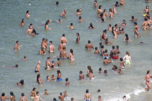 Rio de Janeiro, Brazil. Copacabana beach. Multi racial singles children and family groups in the sea bikinis. Brazil Brasil Brazilian Brasilian South America Latin Latino American City Travel Destination Urban Vacation Beach Beaches People Sunbathing Crowds Rio De Janeiro Copacabana Swimming Sea Swim Wade Wading Paddle Paddling Bikinis Destination Destinations Holidaymakers Kids Latin America Sand Sandy Beach Tourism Seaside Shore Tourist Tourists Vacation Sand Sandy Beaches Tourism Seaside Shore Tourist Tourists Vacation South America Southern Water