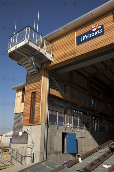 Shoreham-by-Sea, West Sussex, England. Kingston Beach Newly constructed lifeboat house opposite the harbour entrance. England English West Sussex County Shoreham Shoreham-by-Sea by Sea Water Kingston Beach Europe European Architecture Modern Life Boat Lifeboat Lifeboats RNLI Wood Wooden Clad Galvanised Metal Zinc Blue Sky Station Home Timber Frame