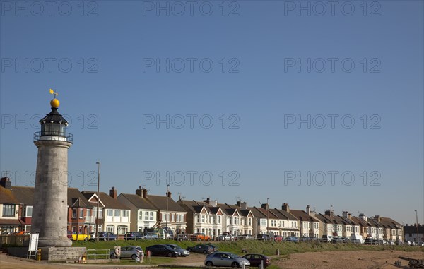 Shoreham-by-Sea, West Sussex, England. Kingston Beach Lighthouse and residential housing along Brighton Road. England English UK United Kingdom GB Great Britain Europe European West Sussex County Shoreham Shoreham-by-Sea By Sea Kingston Beach Light House Lighthouse Warning Beacon Architecture Housing Residential Homes Houses Traffic Blue Sky