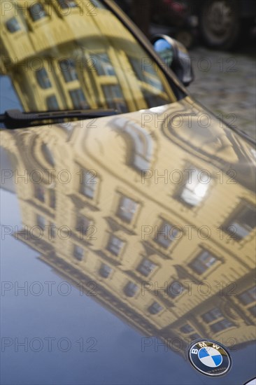 Vienna, Austria. Building facade reflected in bonnet and windscreen of BMW car. Austria Austrian Republic Vienna Viennese Wien Europe European City Capital Reflect Reflected Reflection Building Buildigs Architecture Car Auto Automobile Bonnett Hood Bodywork Paint Paintwork Windscreen Windshield BMW Emblem Logo Automotive Autom—vil Cars Destination Destinations Motorcar Osterreich Reflexion Viena Western Europe