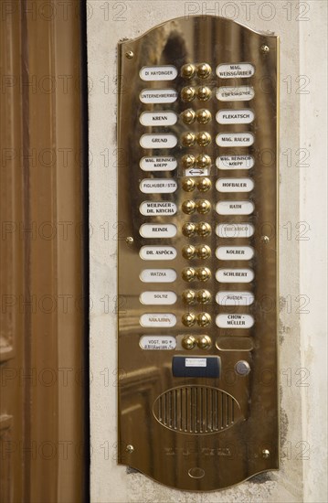 Vienna, Austria. Polished brass bell and names of residents at entrance to apartment. Austria Austrian Republic Vienna Viennese Wien Europe European City Capital Architecture Building Entrance Door Bell Doorbell Bells Names Numbers Brass Panel Plate Speaker Entry Flat Osterreich Viena Western Europe