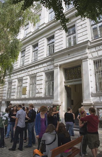 Vienna, Austria. Neubau District. Students gathered outside college building entrance. Austria Austrian Republic Vienna Viennese Wien Europe European City Capital NeuBau District Students People Young College Univesity Architecture Building Extrerior Facade Immature Learning Lessons Osterreich Teaching Viena Western Europe