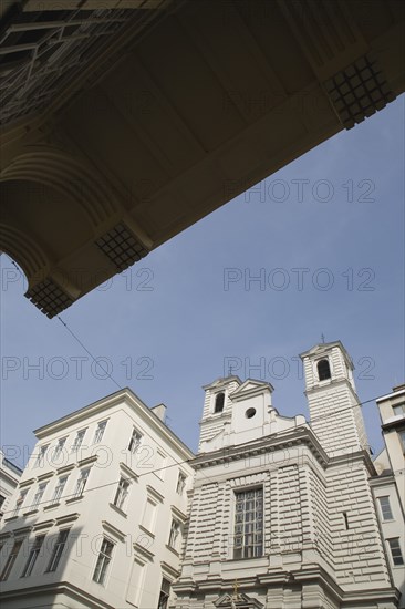 Vienna, Austria. Neubau District. Church exterior viewed from beneath awning of apartment building opposite. Austria Austrian Republic Vienna Viennese Wien Europe European City Capital neubau District Architecture Buildings Religious Christian Church Religion Christianity Exterior Facade Awning Blue Color Destination Destinations Flat Osterreich Religion Religious Christianity Christians Viena Western Europe