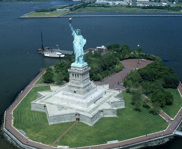 New York, New York State, USA. Statue of Liberty. Star shaped plinth river with moored island ferry American Destination Destinations North America Northern United States of America