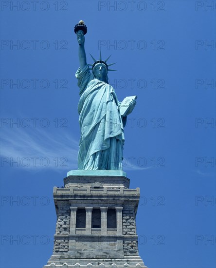 New York, New York State, USA. Statue of Liberty. Close view on plinth torch with gold flame American Blue Color Destination Destinations North America Northern United States of America