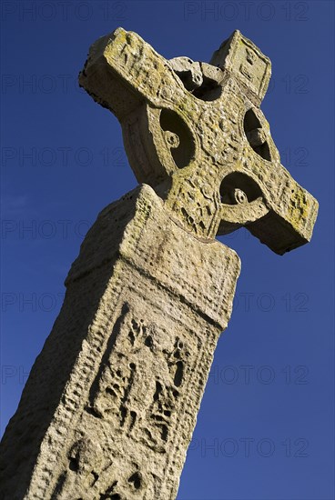 Clones, County Monaghan, Ireland. Celtic Cross against blue sky. Ireland Irish Eire Erin Europe European Republic History Early Christian Christianity Celtic Celt Celts Cross Crucifix Crosses Bible Sculpture Monasticism Religion Religious Color Destination Destinations Gray Northern Europe Poblacht na hEireann Religion Religious Christianity Christians Colour Grey