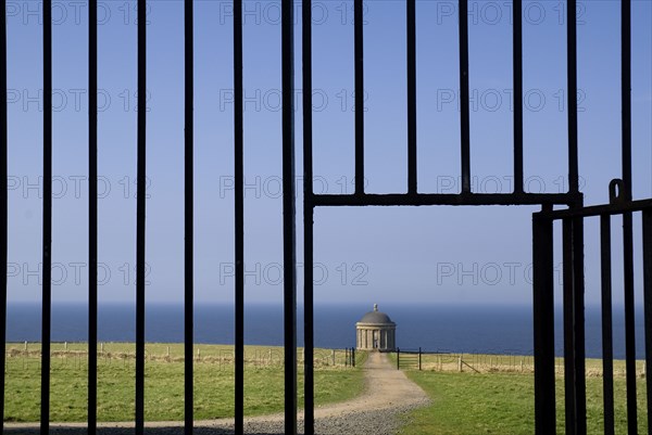 Mussenden Temple, County Derry, Ireland. Built as a library and modelled on the Temple of Vesta in Italy. Ireland Irish Eire Erin Europe European North Northern Derry Londonderry Mussenden Temple Library Architecture Folly Follie Blue Sky Color Destination Destinations Gray History Historic Italia Italian Northern Europe Poblacht na hEireann Republic Southern Europe Colour Grey