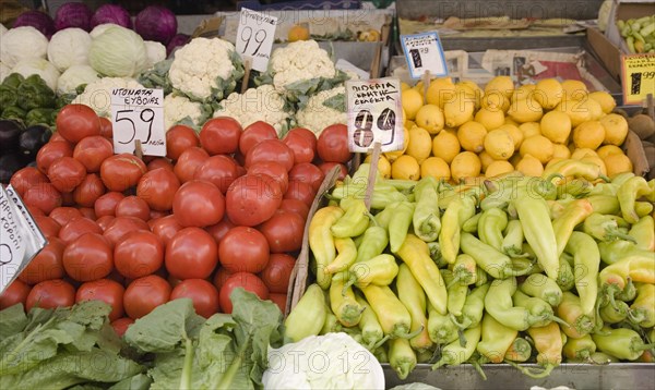 Athens, Attica, Greece. Central market. Display of fruit and vegetable summer produce on grocers stall including lemons tomatoes cauliflower lettuce and peppers. Greece Greek Europe European Vacation Holiday Holidays Travel Destination Tourism Ellas Hellenic Central Central Market Food Stall Shop Store Display Price Prices Fruit Vegetables Grocery Groceries Fooddtuff Foodstuffs Atenas Athenes Color Destination Destinations Ellada Southern Europe