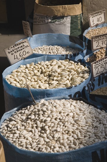 Athens, Attica, Greece. Sacks of beans for sale on food stall in central market. Greece Greek Europe European Vacation Holiday Holidays Travel Destination Tourism Ellas Hellenic Attica Athens Central Market Beans Pulses Dried Goods Food Sacks Display Price Card Prices Atenas Athenes Destination Destinations Ellada Southern Europe