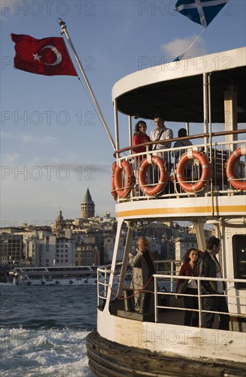 Istanbul, Turkey. Sultanahmet. Crowded passenger ferry flying Turkish flag on the Bosphorous with city behind. Since March 2006 Istanbuls traditional commuter ferries have been operated by Istanbul Sea Buses. Turkey Turkish Istanbul Constantinople Stamboul Stambul City Europe European Asia Asian East West Urban Sultanahmet Bosphorous Destination Travel Tourism Transport Water Ship Boat Ferry Commuter Cummuters Classic Classical Destination Destinations Historical Middle East Older South Eastern Europe Turkiye Water Western Asia