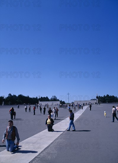 Fatima, Biera Litoral, Portugal. Pilgrims on knees making thier way toward the church & shrine Portuguese Religion Southern Europe