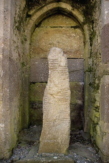 Ardmore, County Waterford, Ireland. Monastic Site Ogham Stone in the Cathedral. Ireland Irish Eire Erin Europe European County Waterford Adrmore Monastic Monastery Ruin Site Ogham Stone Cathedral Religion Religious Christian Christianity Destination Destinations History Historic Northern Europe Poblacht na hEireann Religion Religious Christianity Christians Republic