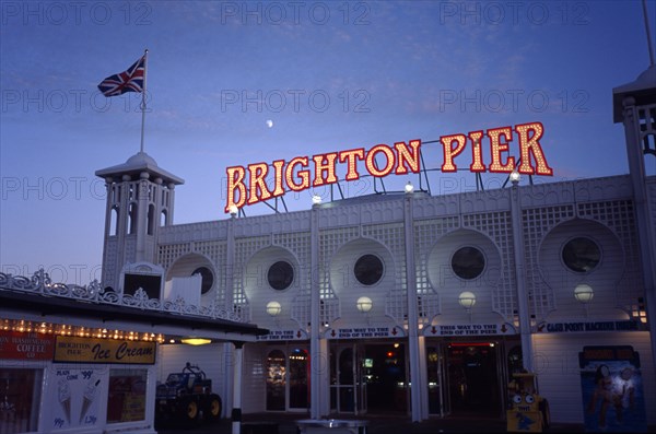 Brighton, Sussex, England. Brighton Pier sign illuminated over pier arcade entrance at night European Great Britain Nite Northern Europe Signs Display Posted Signage UK United Kingdom