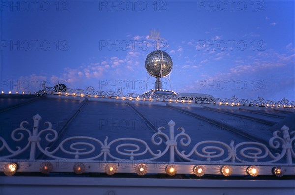 Brighton, East Sussex, England. Brighton Pier roof detail with mirrored ball and lights illuminated at night European Great Britain Nite Northern Europe UK United Kingdom