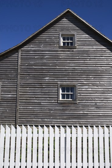 Omagh, County Tyrone, Ireland. Ulster American Folk Park Western Pennsylvania Log House detail of wooden gable and whitc picket fence. Ireland Irish Eire Erin Europe European North Northern County Tyrone Omagh Ulster American US Folk Park Museum Living Tour Tourism Tourist Attraction Travel Fence Picket White Sky Blue Cabin Logs Architecture Pennsylvania Log Farmhouse Clapperboard Grey Gray Wood Wooden Color Destination Destinations History Historic Keystone State Northern Europe Poblacht na hEireann Republic Sightseeing Tourists Colour Holidaymakers