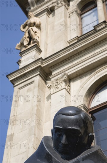 Budapest, Pest County, Hungary. Detail of bronze statue in front of art nouveau building facade. Hungary Hungarian Europe European East Eastern Buda Pest Budapest City Art Nouveau Statue Male Figure Man Bronze Metal Destination Destinations Eastern Europe Male Men Guy