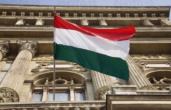 Budapest, Pest County, Hungary. Hungarian flag flying from building facade. Hungary Hungarian Europe European East Eastern Buda Pest Budapest City Green White Red Tricolour Tricolor Flag Detail Facade Architecture Destination Destinations Eastern Europe
