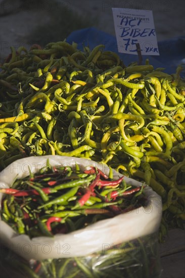 Kusadasi, Aydin Province, Turkey. Red and green chilies for sale on stall at weekly market. Turkey Turkish Eurasia Eurasian Europe Asia Turkiye Aydin Province Kusadasi Market Markets Stall Display Chili Chilli Chillie Chilis Chillis Chillies Capsicum Capsicums Pepper Peppers Green Red Multi Muliple Color Colour Colors Colours Colored Coloured Destination Destinations European Middle East South Eastern Europe Western Asia