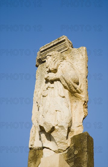 Selcuk, Izmir Province, Turkey. Ephesus. Ruined masonry and relief carving in antique city of Ephesus on the Aegean sea coast. Turkey Turkish Eurasia Eurasian Europe Asia Turkiye Izmir Province Selcuk Ephesus Ruin Ruins Roman Column Columns Facde Ancient Architecture Masonry Rock Stone Destination Destinations European History Historic Middle East South Eastern Europe Water Western Asia