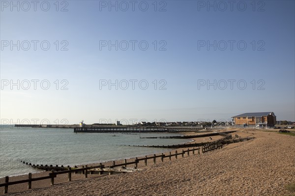 Shoreham-by-Sea, West Sussex, England. Kingston Beach Newly constructed lifeboat house opposite the harbour entrance. England English West Sussex County Shoreham Shoreham-by-Sea by Sea Water Kingston Beach Europe European Architecture Modern Life Boat Lifeboat Lifeboats RNLI Wood Wooden Clad Galvanised Metal Zinc Blue Sky Station Home Timber Frame Groynes Breaks