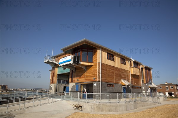 Shoreham-by-Sea, West Sussex, England. Kingston Beach Newly constructed lifeboat house opposite the harbour entrance. England English West Sussex County Shoreham Shoreham-by-Sea by Sea Water Kingston Beach Europe European Architecture Modern Life Boat Lifeboat Lifeboats RNLI Wood Wooden Clad Galvanised Metal Zinc Blue Sky Station Home Timber Frame