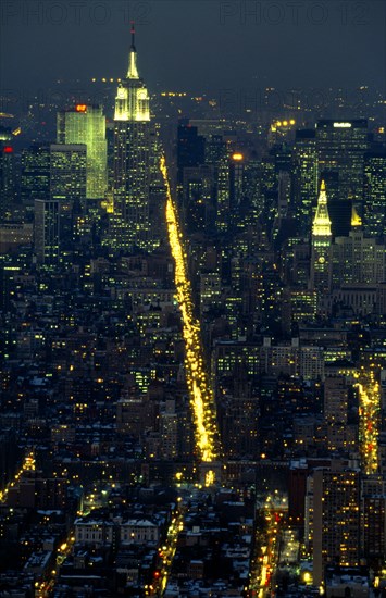 New York, New York State, USA. The Empire State Building illuminated at night with the city spread out below. American Nite North America United States of America