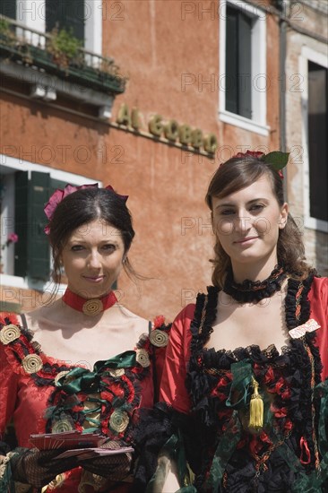 Venice, Veneto, Italy. Portrait of two young women wearing traditional costume to promote Venice Casino. Italy Italia Italian Venice Veneto Venezia Europe European City Women Woman Girl Girls Female Traditional Dress Costume 2 Classic Classical Destination Destinations Female Woman Girl Lady Female Women Girl Lady Historical Immature Older Southern Europe