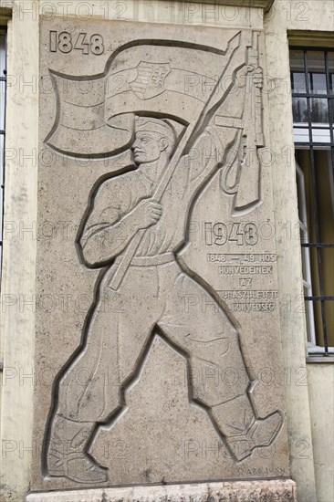 Budapest, Pest County, Hungary. 1848 Revolution memorial depicting soldier holding flag and rifle aloft. The national insurrection against the Habsburgs began in the Hungarian capital in 1848 and was defeated little more than a year later. Hungary Hungarian Europe European East Eastern Buda Pest Budapest City Meorial 1848 Revolution Soldier Carved Stone Destination Destinations Eastern Europe History Historic