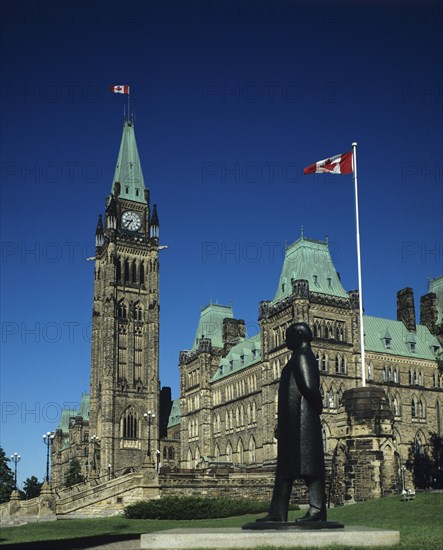 Ottawa, Ontario, Canada. Parliament building with green roof and flags flying. Canada Canadian Ontario State Ottawa City Capital North America Parliament Politics Political Architecture Exterior Facade Green Roof Flag Flags Red White Maple Leaf Clock Clocktower Tower Blue Sky Statue Sculpture Figure male Black Art Arts American Destination Destinations North America Northern Parliment