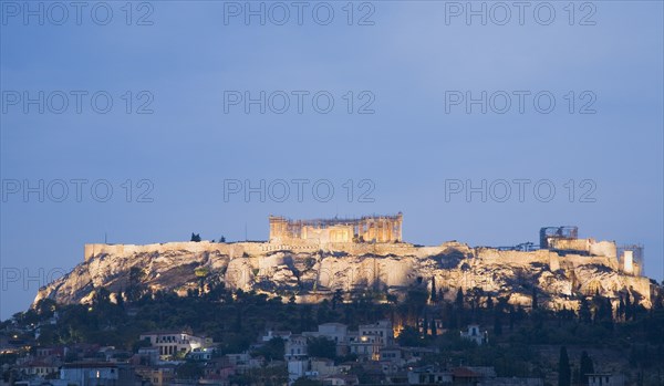 Athens, Attica, Greece. View towards the Acropolis on hilltop above Athens illuminated at dusk. Greece Greek Europe European Vacation Holiday Holidays Travel Destination Tourism Ellas Hellenic Attica Athens City Acropolis Ruins Ruin Night Nighttime Lit Illuminated Lit-up Evening Dusk Atenas Athenes Destination Destinations Ellada History Historic Nightfall Twilight Evenfall Crespuscle Crespuscule Gloam Gloaming Nite Southern Europe Warm Light
