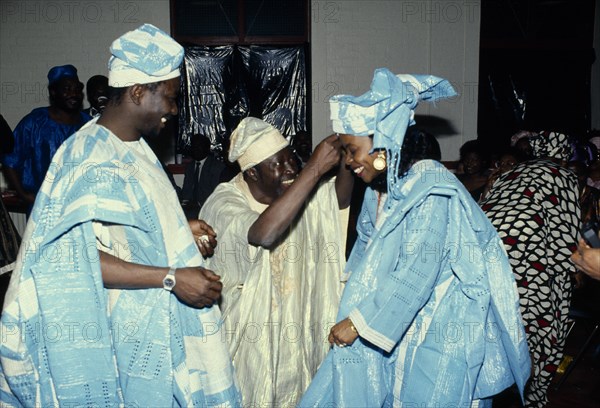 Weddings, Religion, Nigeria. Bride and Groom at traditional wedding dressed in traditional clothing. African Classic Classical Historical Immature Marriage Marrying Espousing Hymeneals Nuptials Nigerian Older Religion Religious Western Africa