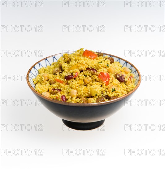 Bowl of vegetarian couscous with fruit on a white background. Food Cooked Couscous Cous cous Bowl Dish Platter Portion Meal Serving Maroc Morocco Moroccan Fruits Fruit Nut Nuts Vegetable Vegetables Vegetarian Yellow Pasta Cookery Cooking North Africa African Middle East Eastern Grain Durum Wheat Semolina al Magrib Cereal Grain Crop Color North Africa Northern