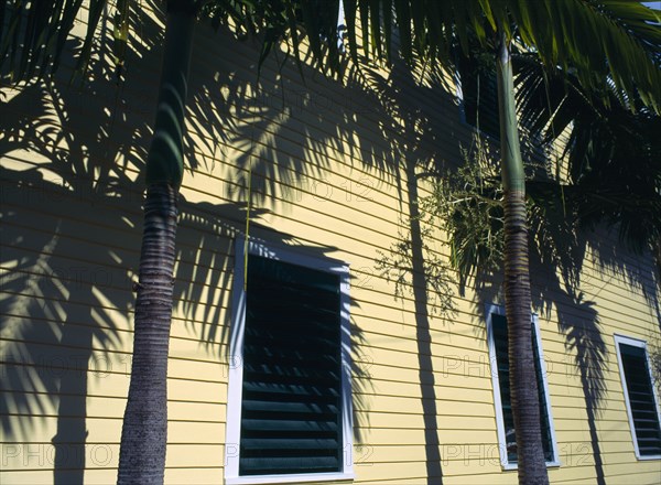 Key West, Florida, USA. Detail of shuttered wooden building with palm trees Clapperboard American North America United States of America Northern Sunshine State