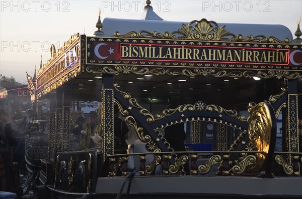 Istanbul, Turkey. Sultanahmet. Traditional fish restaurant boat on the Golden Horn adjacent to Galata with highly decorative black and gold detail to structure. Turkey Turkish Istanbul Constantinople Stamboul Stambul City Europe European Asia Asian East West Urban Destination Travel Tourism Sultanahmet Bosphorous Galata Bridge Cafe Restaurant Floating Boat Ship Golden Hind Fish Food Tradtitional Bar Bistro Classic Classical Color Destination Destinations Historical Middle East Older South Eastern Europe Turkiye Western Asia