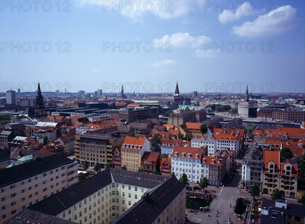 Denmark, Copenhagen, View north-west over city rooftops from the tower of the Church of Our Saviour  with spire of the Royal Palace Christiansborgslott centre right.