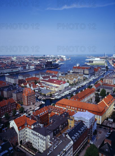 Denmark, Copenhagen, View north over city rooftops and harbour from the tower of the Church of Our Saviour  with the opera house on skyline on right.