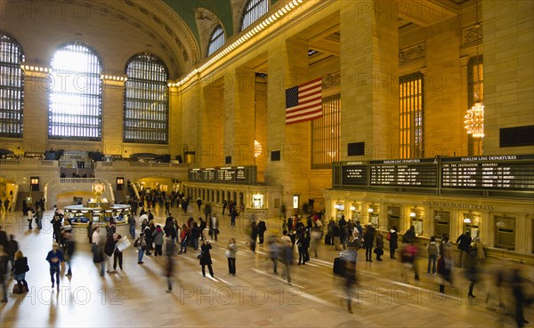USA, New York, New York City, Manhattan  Grand Central Terminal railway station with people walking in the Main Concourse and passengers buying tickets.