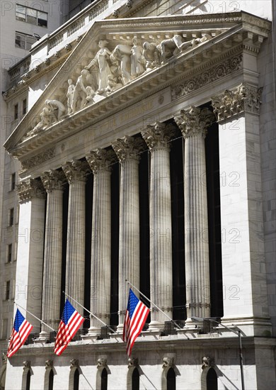 USA, New York, New York City, Manhattan  The New York Stock Exchange building in Broad Street beside Wall Street showing the main facade of the building featuring marble sculpture by John Quincy Adams Ward in the pediment called Integrity Protecting the W