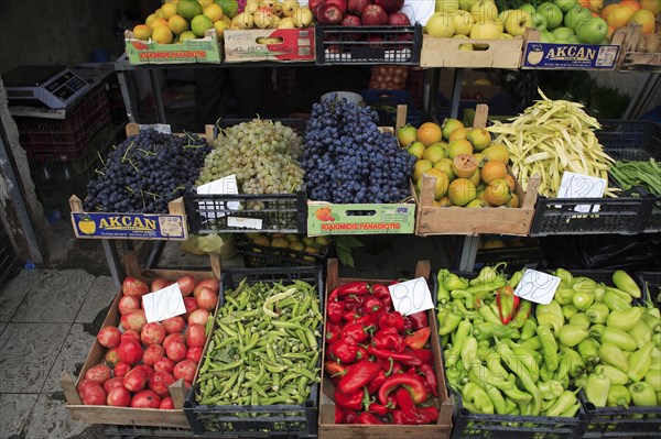 Albania, Tirane, Tirana, Grocers stall in Avni Rustemi Market with fruit and vegetable display including apples  grapes  peppers and okra.