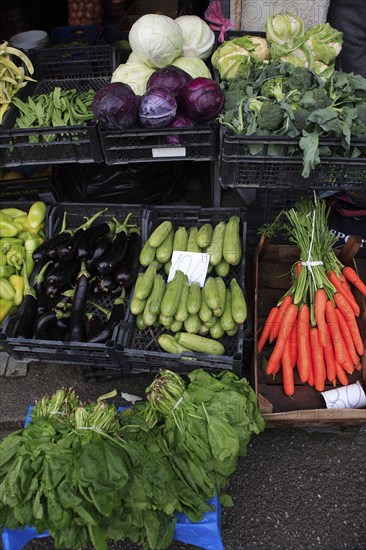 Albania, Tirane, Tirana, Display of fruit and vegetables at grocers stall in the Avni Rustemi Market including aubergines  cabbage and carrots.