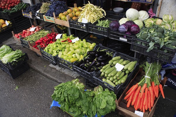 Albania, Tirane, Tirana, Display of fruit and vegetables at grocers stall in the Avni Rustemi Market including aubergines  cabbage and carrots.