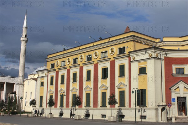Albania, Tirane, Tirana, Exterior facade of government buildings beside Ethem Bey Mosque and minaret on Skanderbeg Square.