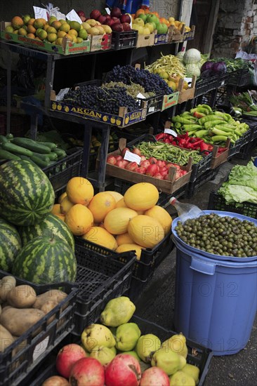 Albania, Tirane, Tirana, Grocers fruit and vegetable display in the Avni Rustemi Market including grapes  melons  peppers and olives.