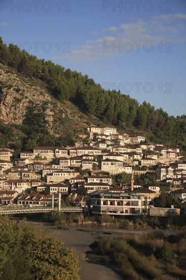 Albania, Berat, Traditional Ottoman buildings on hillside above footbridge over the River Osum.