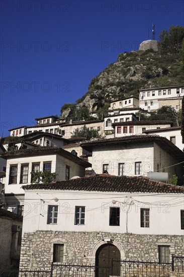 Albania, Berat, Traditional white painted Ottoman houses with tiled rooftops on hillside in the old town.