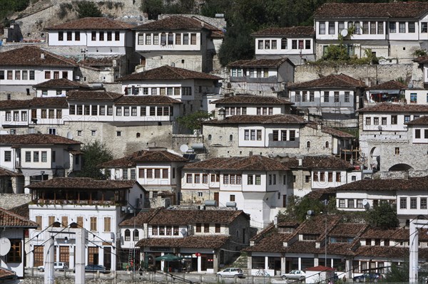 Albania, Berat, Ottoman houses in the old town with white painted exteriors and tiled roof tops.