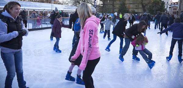 England, East Sussex, Brighton, Royal Pavilion Ice Rink  people skating.