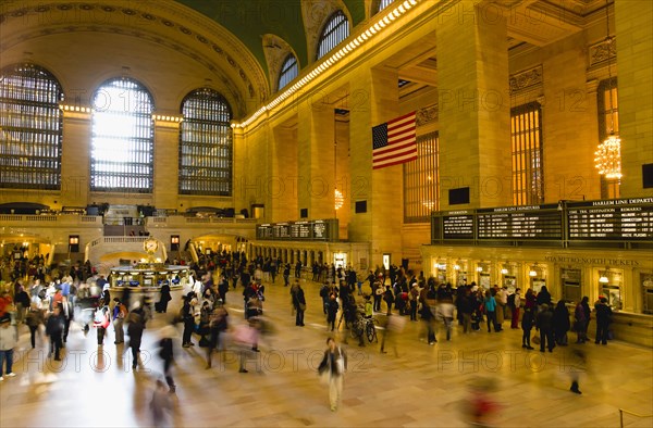 USA, New York, New York City, Manhattan  Grand Central Terminal railway station with people walking in the Main Concourse and passengers buying tickets.