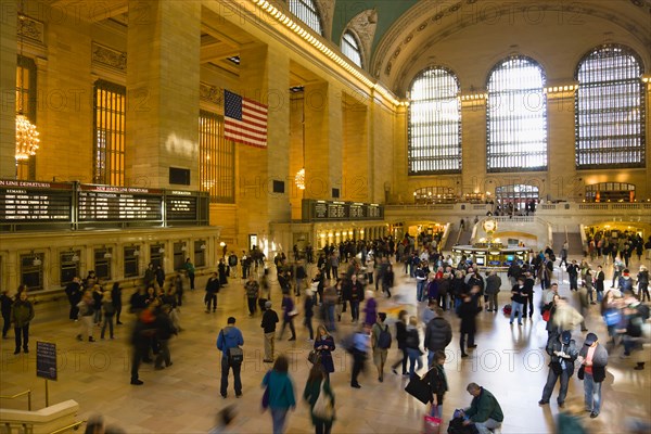 USA, New York, New York City, Manhattan  Grand Central Terminal railway station with people walking in the Main Concourse and passengers buying tickets.