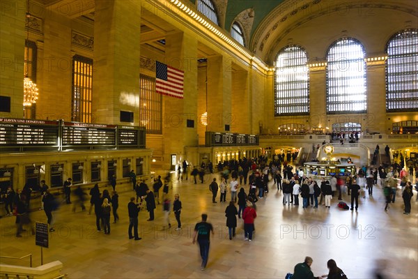 USA, New York, New York City, Manhattan  Grand Central Terminal railway station with people walking in the Main Concourse and passengers buying tickets.